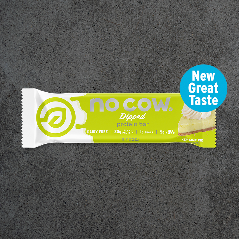 No Cow protein bar packaging on a dark gray background
