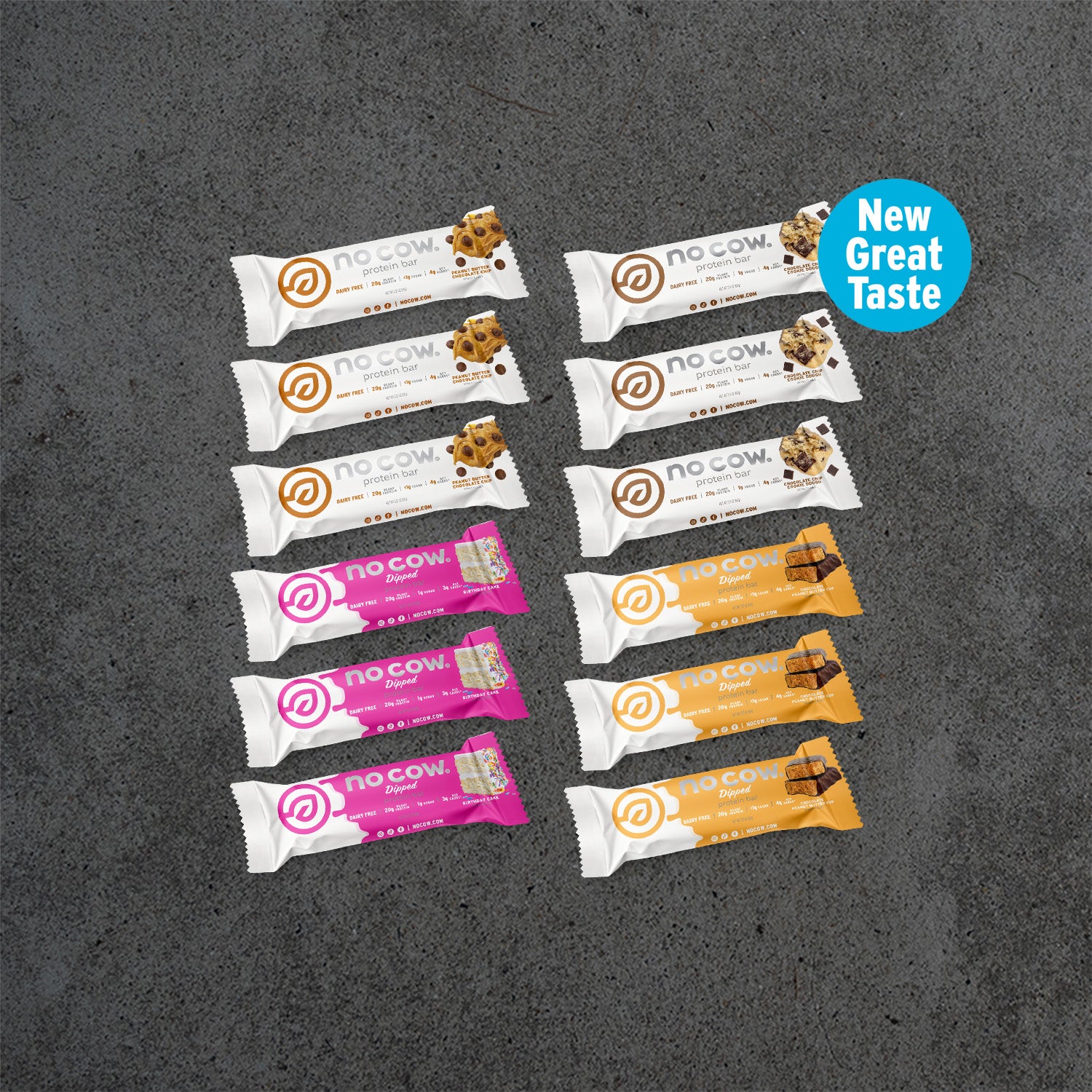 Assorted no cow protein bars on a dark surface with 'New Great Taste' label.